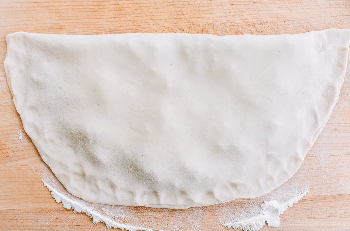 thin dough folded in half with filling