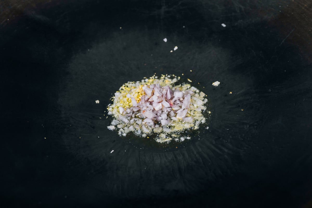 cooking ginger, garlic, and shallots in wok