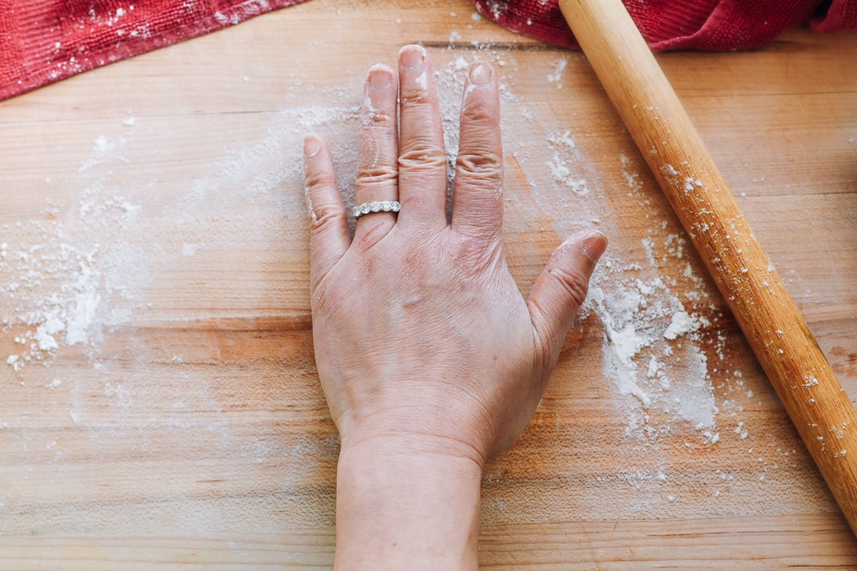 flattening dough with palm of hand