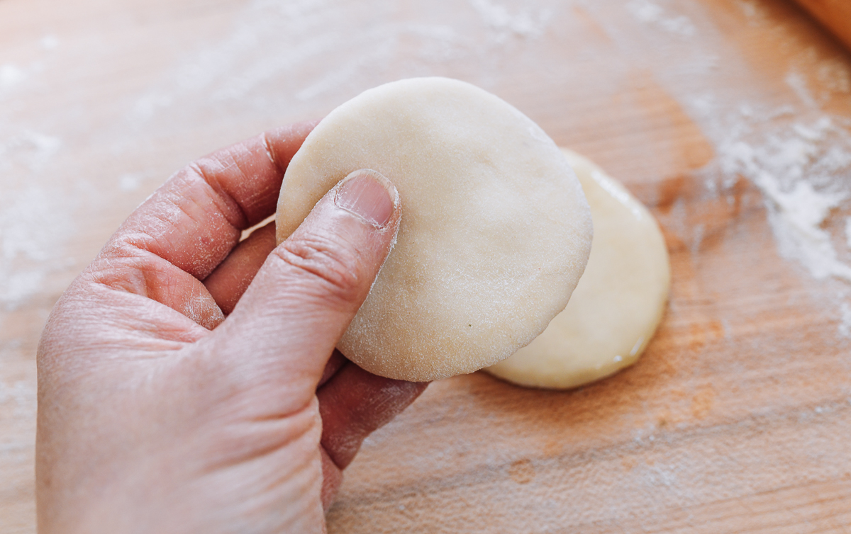 holding circle of dough