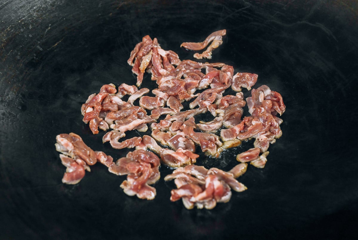 pork strips in wok
