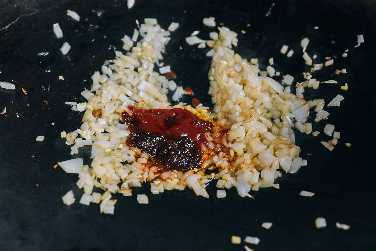 ketchup and shrimp paste in wok with onions