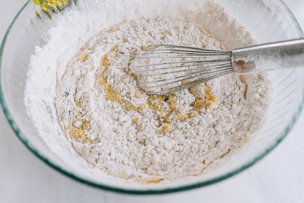 sifted dry ingredients added to batter in bowl