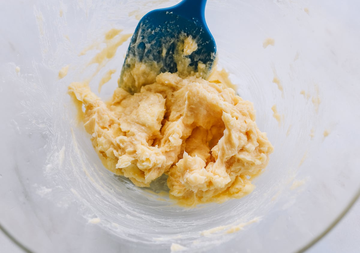 mixing butter, sugar, and vanilla with rubber spatula