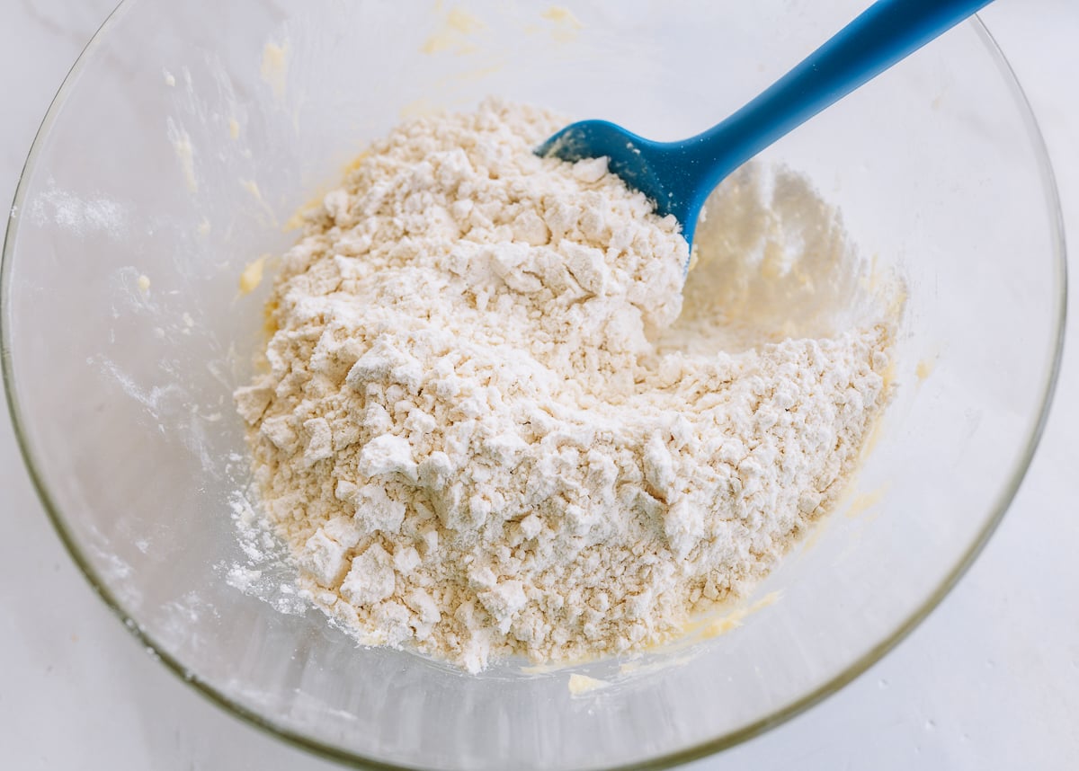 mixing flour in bowl with rubber spatula