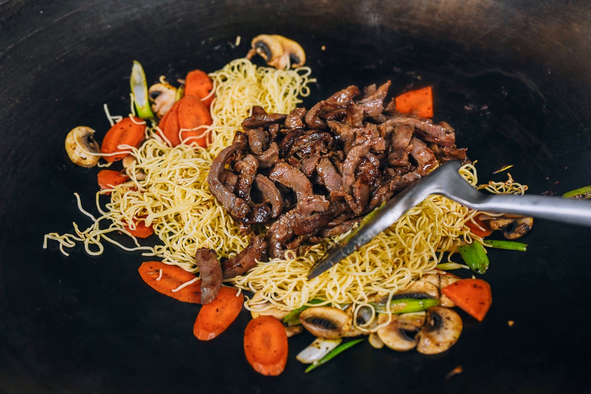 seared beef added to noodles and vegetables