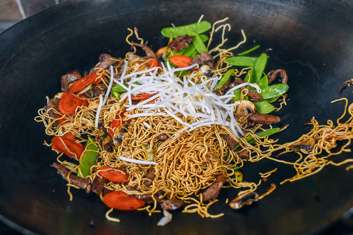 snap peas and mung bean sprouts added to noodles