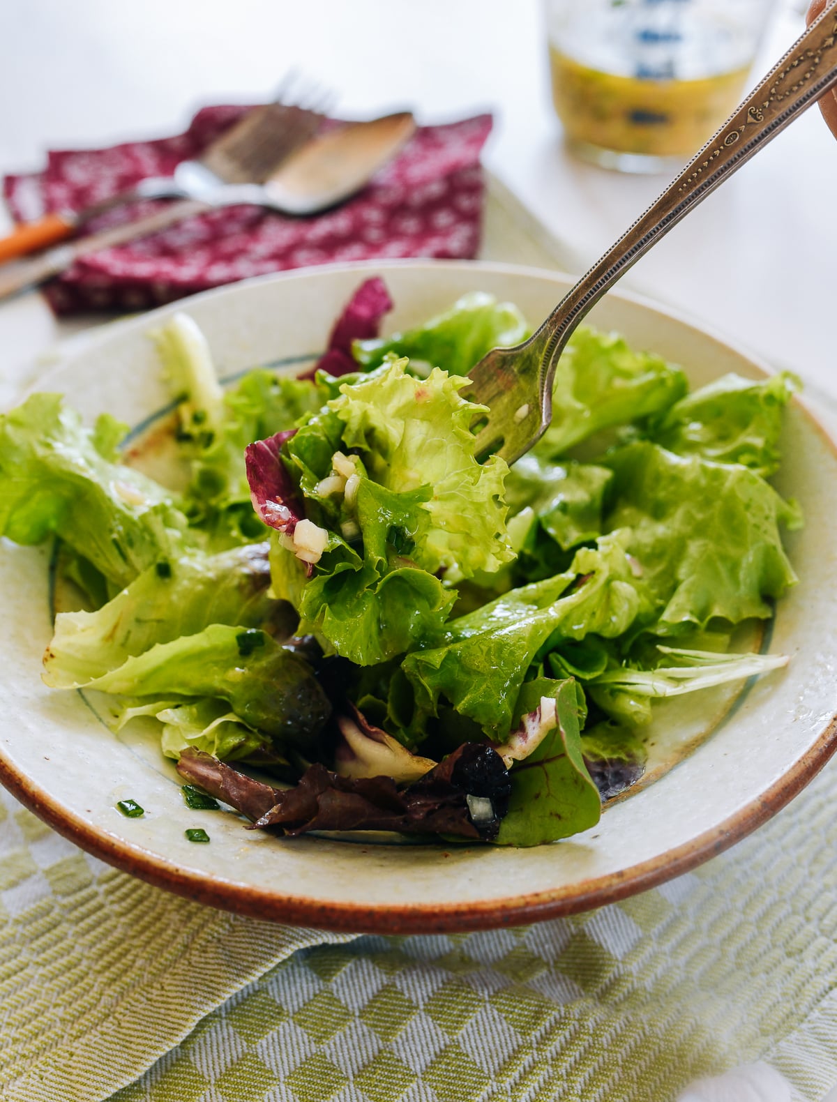 Forkful of mesclun greens with shallot vinaigrette