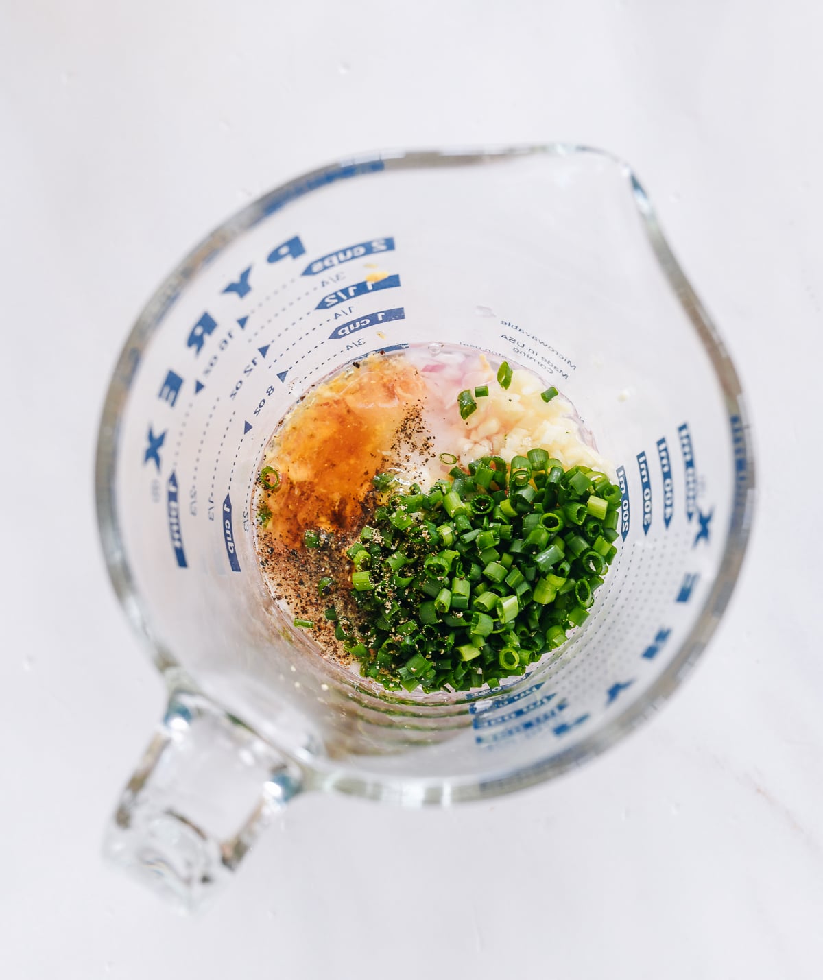 shallot vinaigrette ingredients in measuring cup