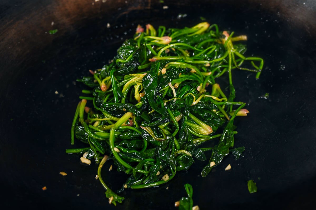 stir-fry spinach in wok