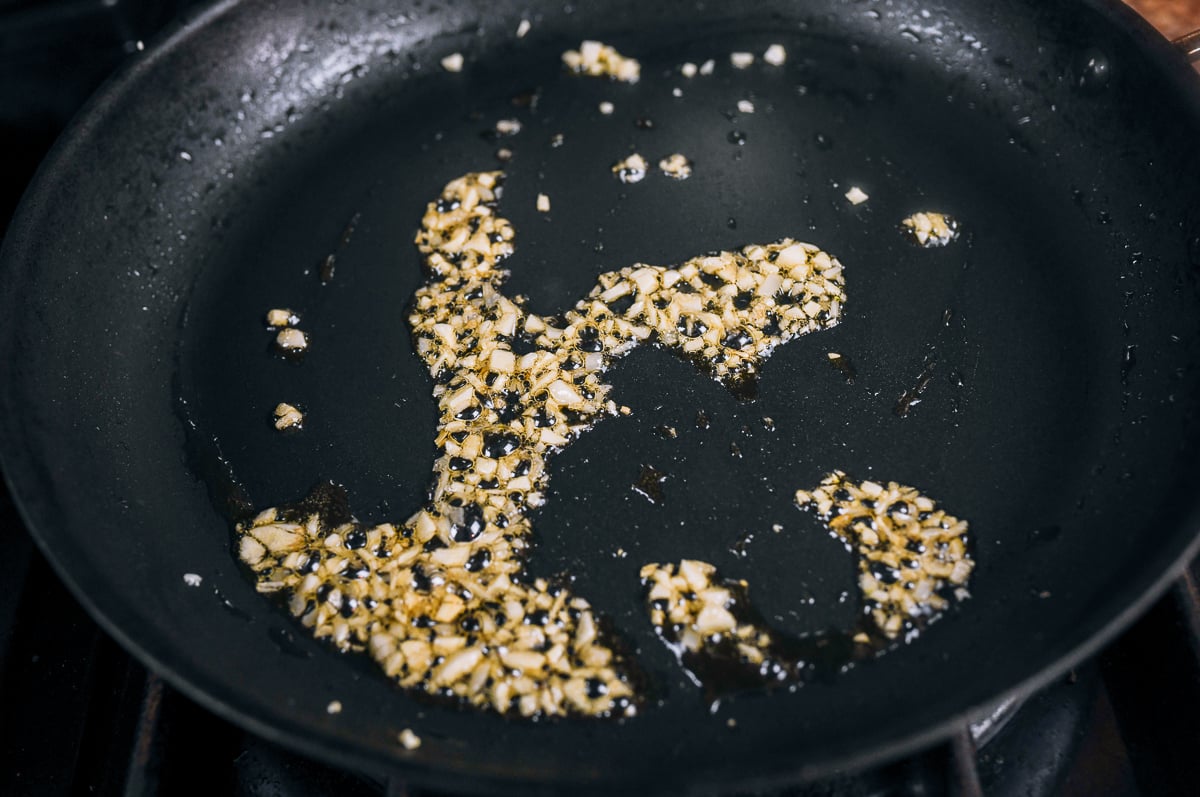 cooking garlic in oiled pan