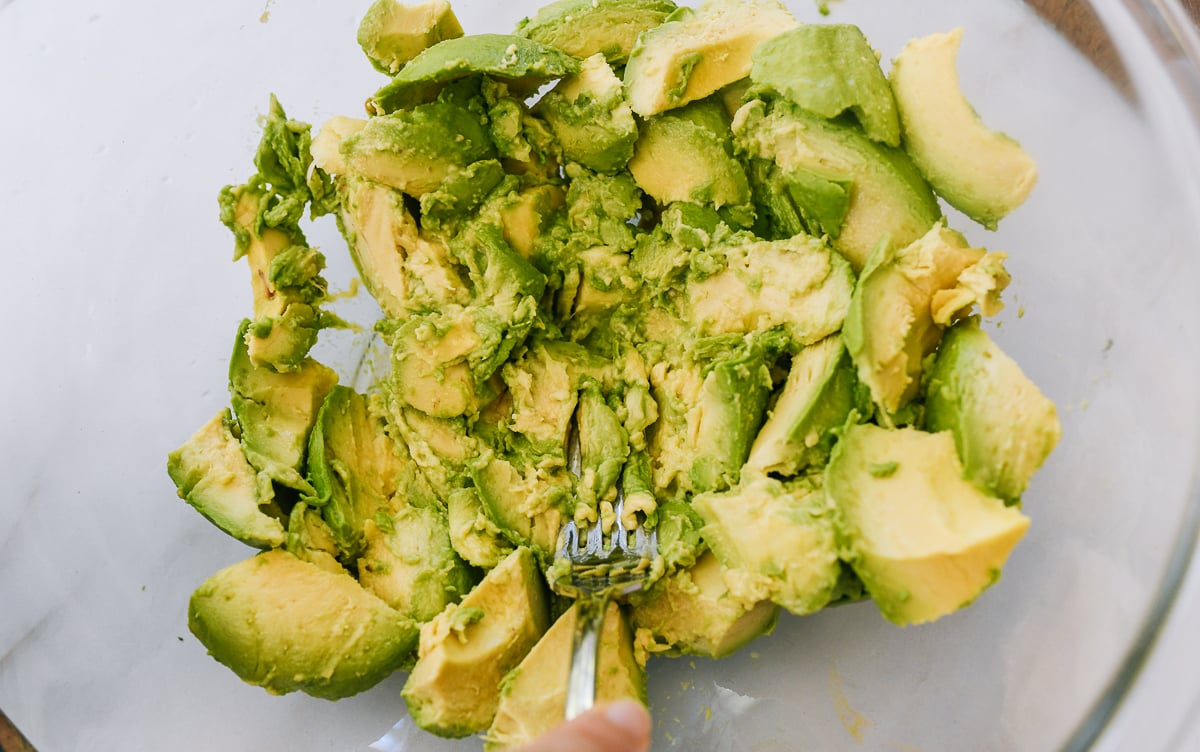 mashing avocado with fork