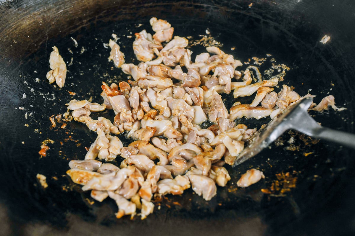 seared chicken pieces in wok