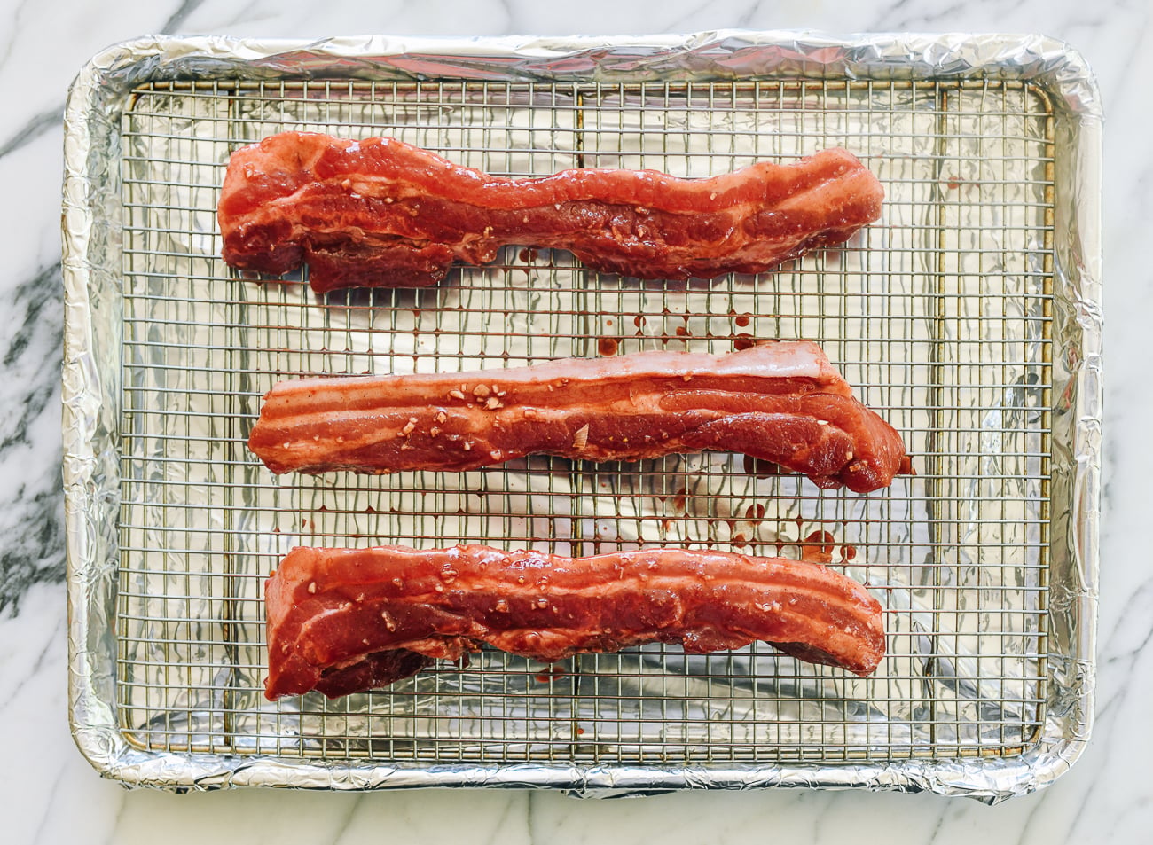 char siu marinated pork belly on roasting rack before cooking
