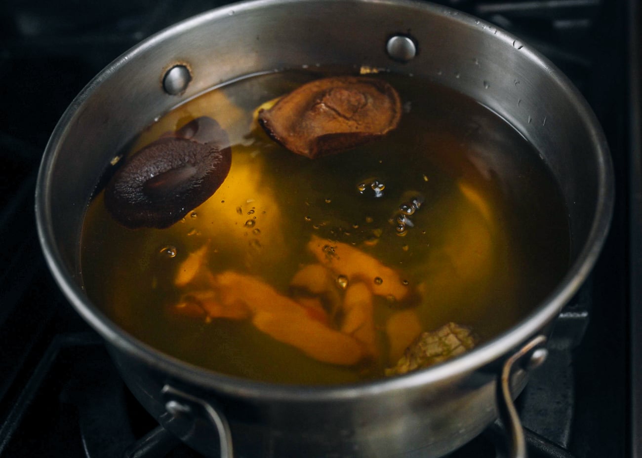 simmering orange peel, ginger, etc. in water