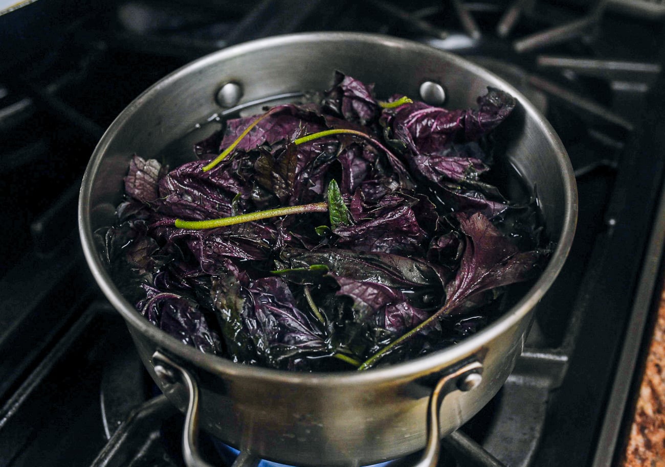 simmering red shiso leaves in water