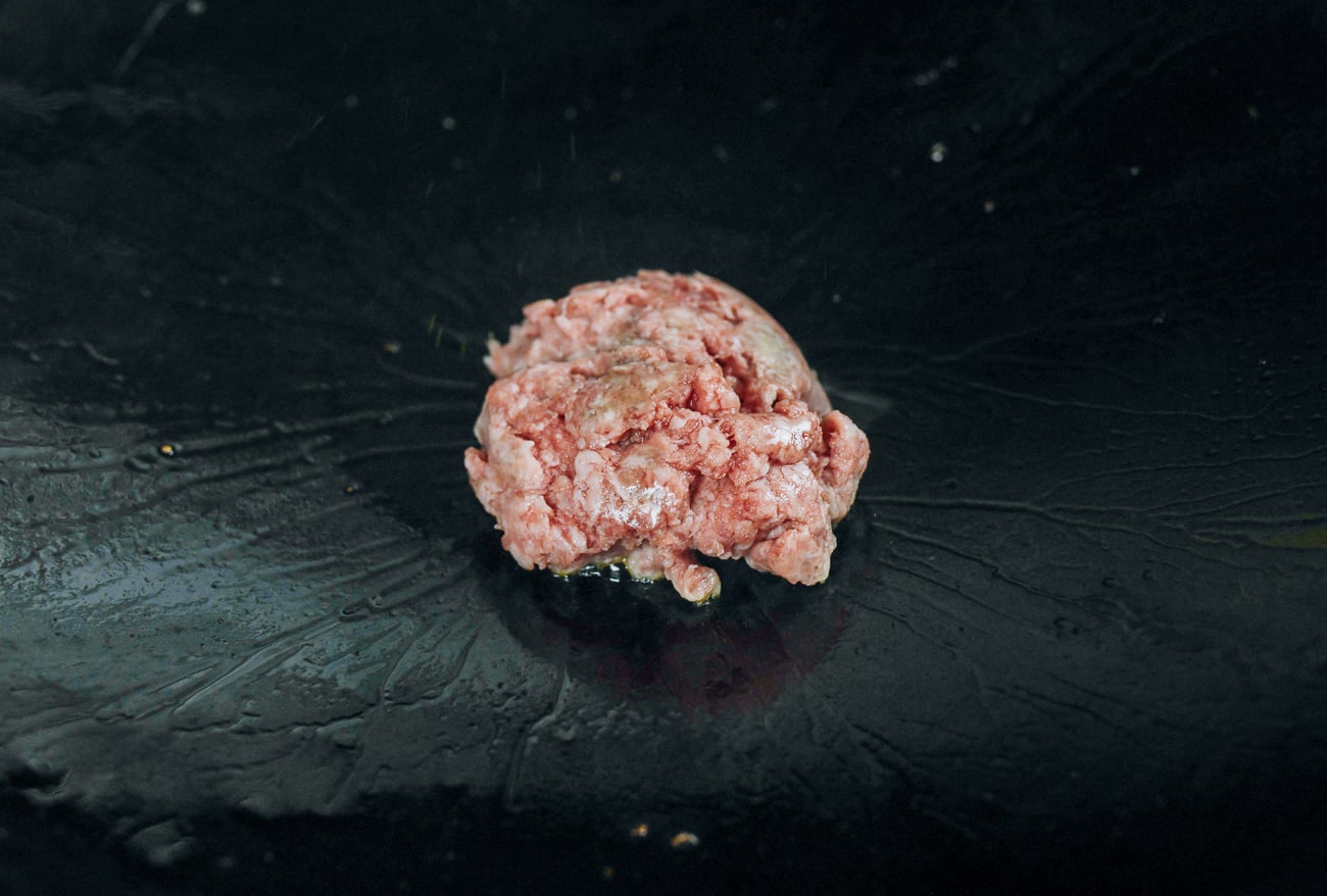 ground pork added to wok